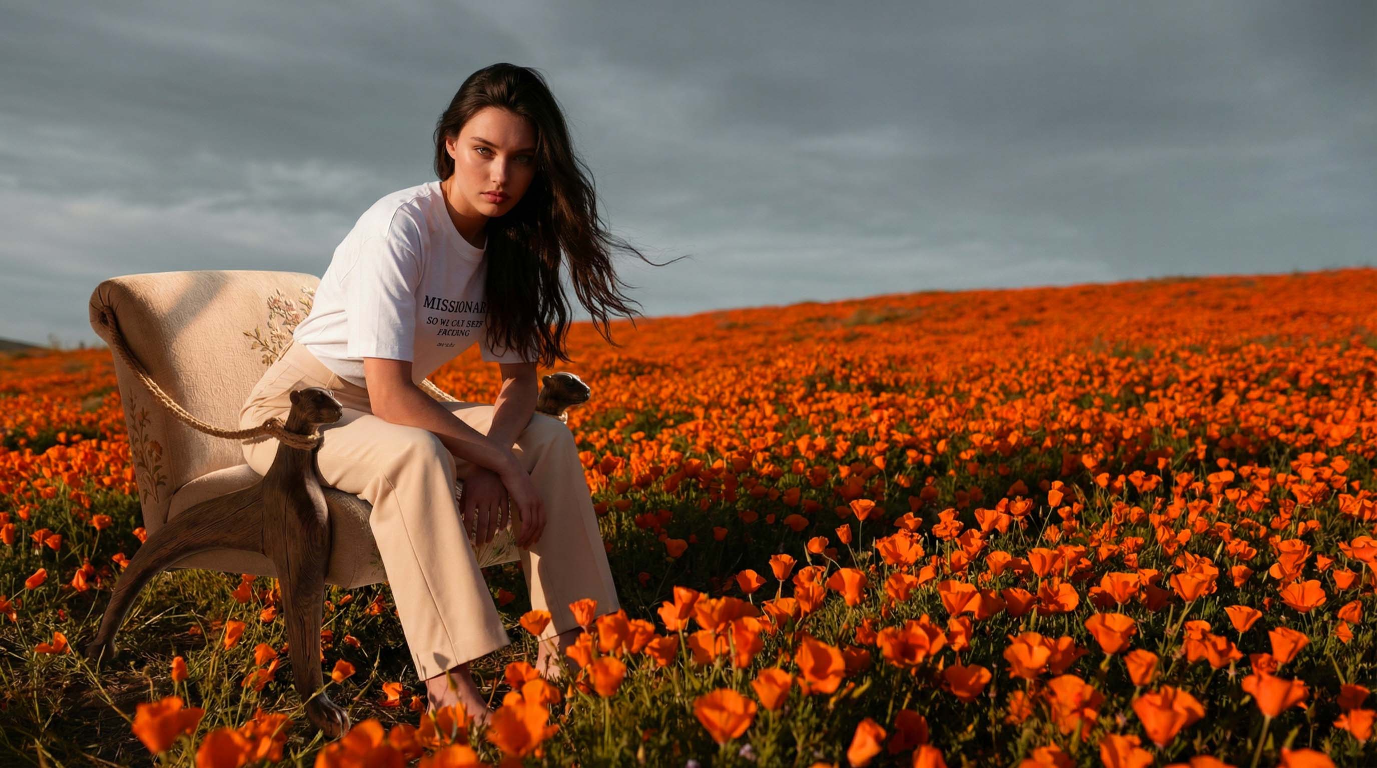 aurulu Missionary Argument oversized tee — model seated in orange poppy field, statement clothing designed in Germany