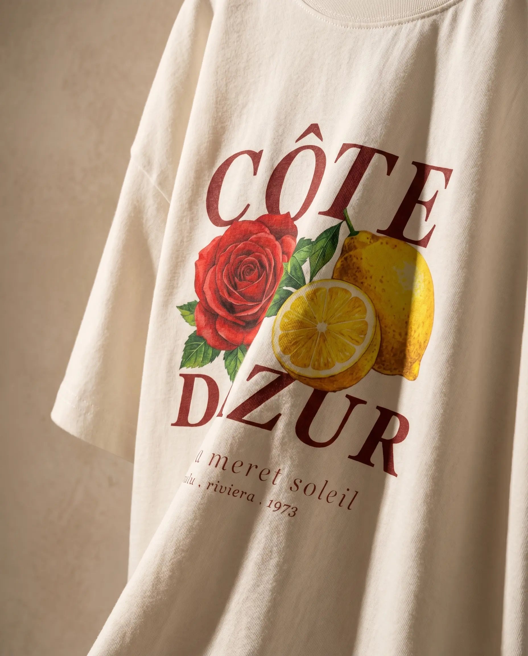 Côte d'Azur women's oversized tee with colorful print, made from comfortable material by aurulu, laid flat showing front view.
