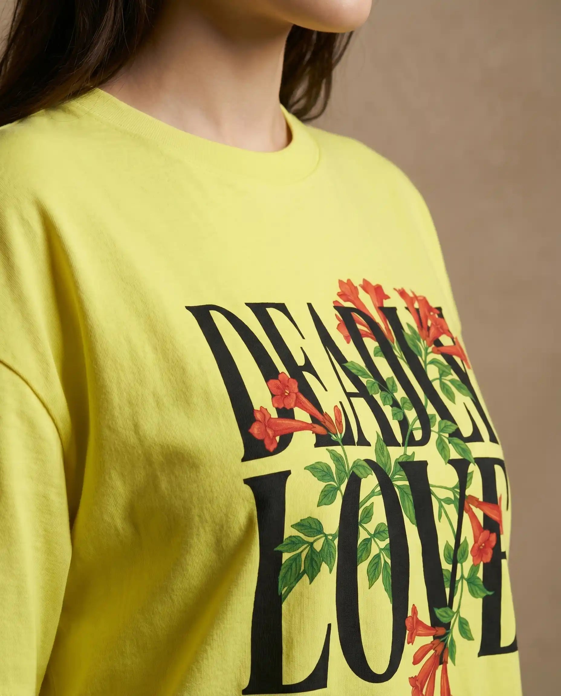 Deadly Love women's oversized T-shirt with bold print design from aurulu, shown in a close-up image featuring the graphic detail.