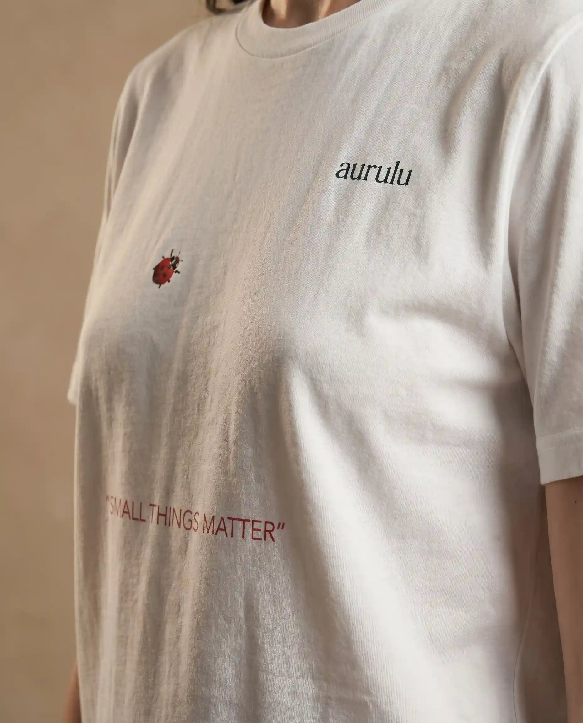 Black women's T-shirt from aurulu with "Small Things Matter" print, casual fit, soft fabric, and short sleeves.