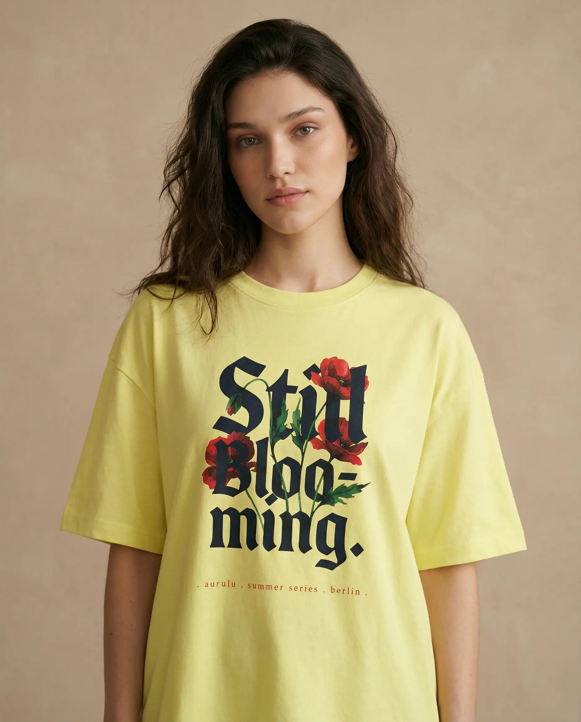 Still Blooming women's oversized print tee by aurulu, featuring a colorful floral design on soft fabric.